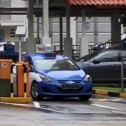 Taxi driver removing parking barrier