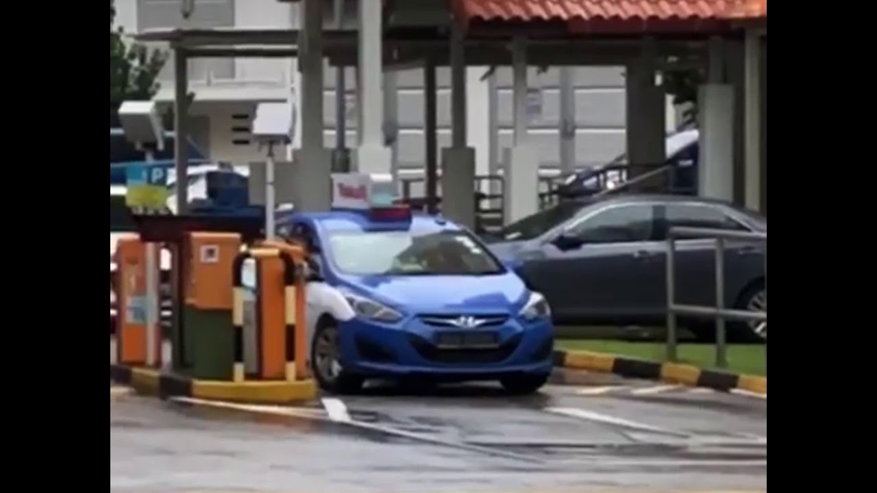 Taxi driver removing parking barrier
