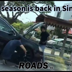 9 persons helping driver with a broken down car.