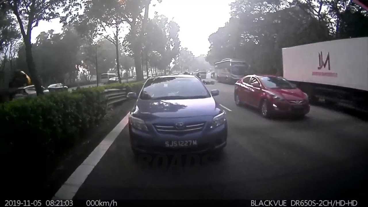 Abrupt cutting in of white car leading to motorcycle hitting rear of another car