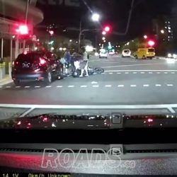 Car did not stop in time and knocked into motorcycle at traffic light.